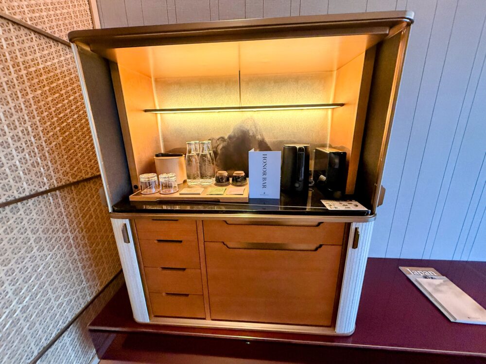 キャビネットの扉を開いた状態。内部がライトアップされ、背景には山のアートが描かれている