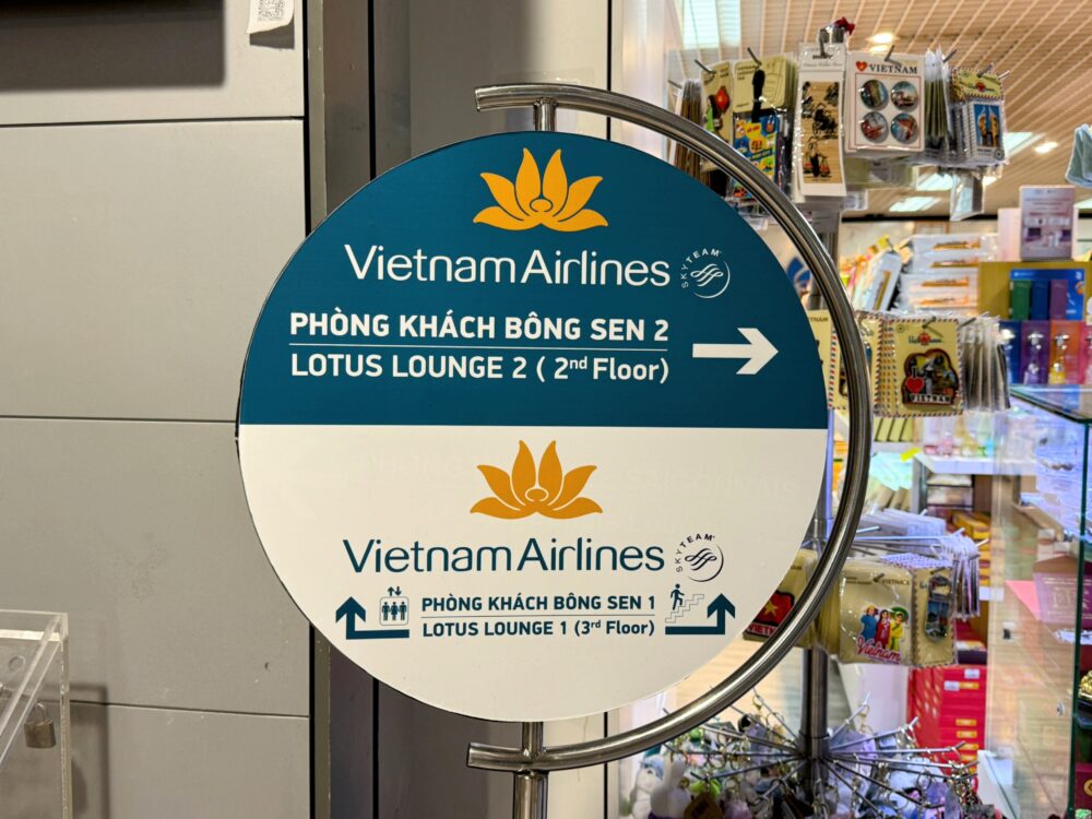 ロータスラウンジの行き先を示す丸い案内看板。2階のロータス2は右、3階のロータス1は上の階であることが示されている。