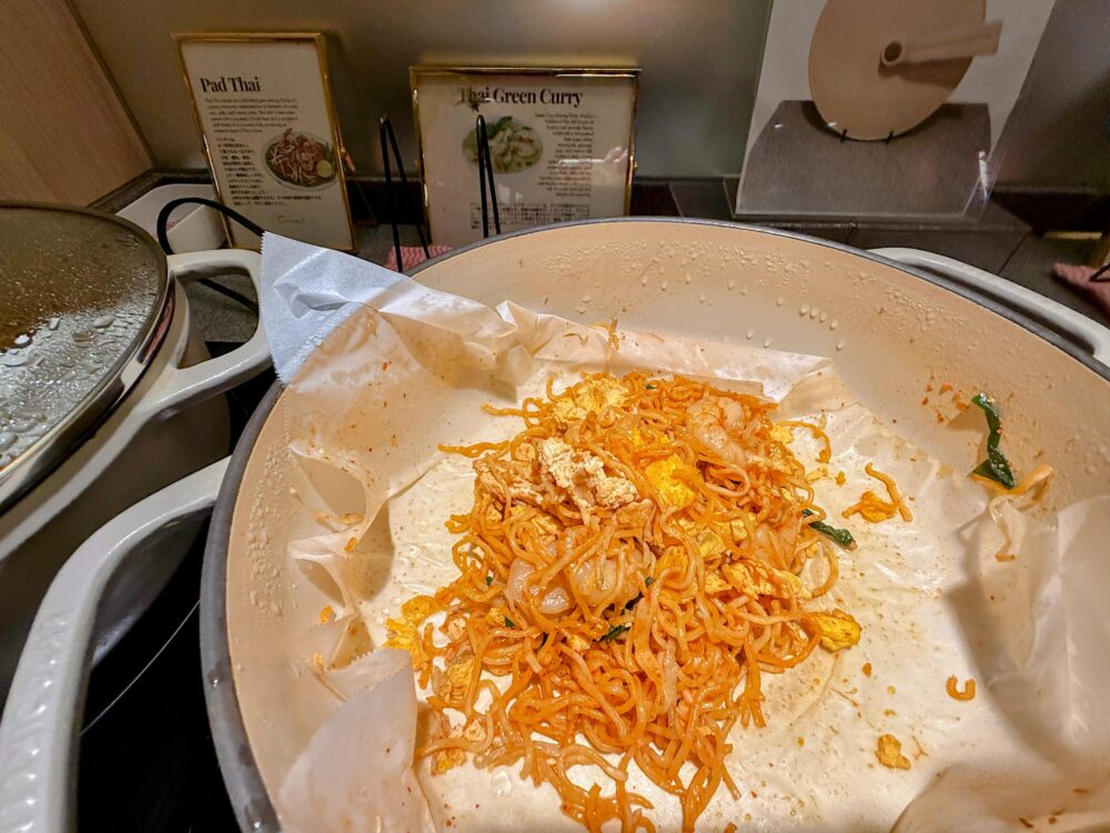 タイの代表的な麺料理「パッタイ（タイ風焼きそば）」。鮮やかなオレンジ色の麺で、甘辛いソースの香りが漂う人気メニュー。