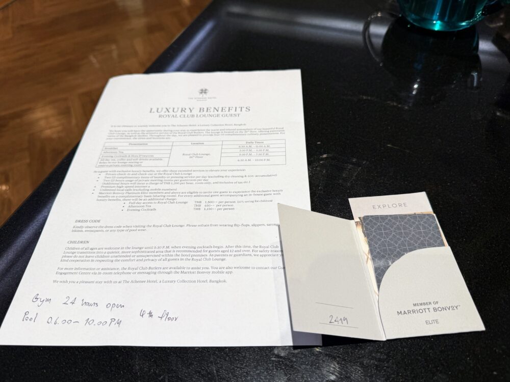 ロイヤルクラブラウンジの案内レター(LUXURY BENEFITS)とルームキー。朝食やアフタヌーンティーの提供時間が記載され、ジム・プールの営業時間が手書きで添えられている。