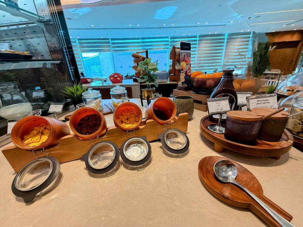 シリアル用のジャー、蜂蜜のボトル、ピーナッツバターなどが置かれたカウンター。